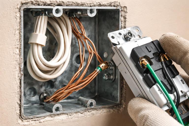 Close-up, realistic photo of an open electrical device box showing clearly separated neutral white wire bundle with wirenut, bare copper grounds bonded to a metal box, and a smart switch being inspected; emphasis on correct neutral vs ground termination, high detail, natural indoor lighting, safety-focused composition.